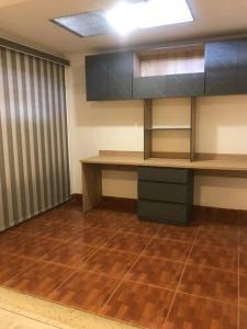 a room with a desk and cabinets and a wooden floor at Apartamento en el centro de Pitalito in Pitalito