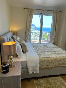 a bedroom with a bed with a view of the ocean at Casa Del Mar in Ponta do Sol