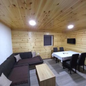 - un salon avec un canapé et une table dans l'établissement Guest House RG, à Žabljak