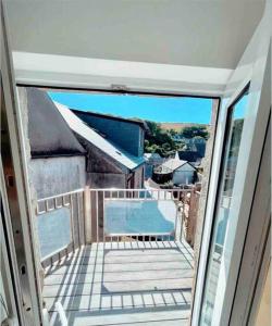 a balcony with a view of a swimming pool at The View, Kingsand, luxurious seafront penthouse apartment with sun trap balcony and incredible sea views in Kingsand