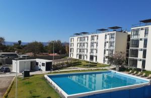 a view of a building and a swimming pool at Departamento Tipo Loft, zona ajijic. in Jocotepec