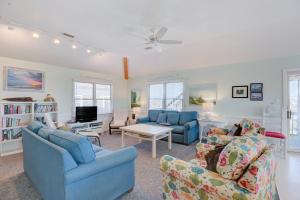 a living room with two blue couches and a tv at Gray Haven #11-DE in Avon