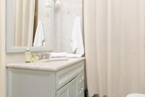 a bathroom with a sink and a shower curtain at Da Rita Affittacamere in Pisa +21 photos