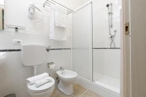 a white bathroom with a toilet and a shower at Da Rita Affittacamere in Pisa