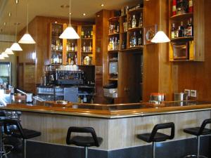 a bar in a restaurant with black stools at Hotel el Paraiso in Caleta De Velez