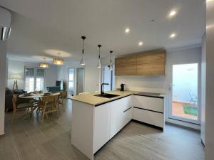 a kitchen and living room with a table and a dining room at El Piset 124 in Benissa