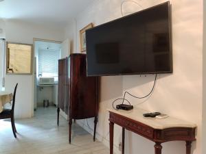 TV de pantalla plana colgada en una pared con mesa en departamento completo en nueva Córdoba en Córdoba