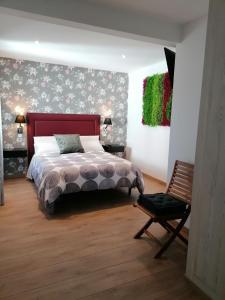 a bedroom with a bed and a chair at Las Vistas in Buendía