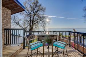 a deck with two chairs and a table with a grill at Paradise Waterfront Cottage (35 Min Drive From Toronto) in Georgina