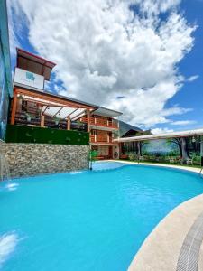 a large swimming pool in front of a building at Esperanza Hotel - Oxapampa in Oxapampa