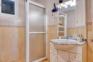 a bathroom with a sink and a shower at Casa do Valentim, a Home in Madeira in Ponta do Sol