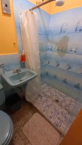 a bathroom with a sink and a toilet at Hotel Maya America in Panajachel