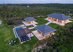 an aerial view of a house with a swimming pool at Ananda House estate in Governorʼs Harbour