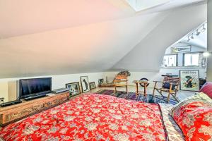 a bedroom with a large bed and a tv at Cozy Catskills Vacation Rental with Deck! in Fleischmanns