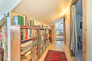 a hallway with book shelves filled with books at Cozy Catskills Vacation Rental with Deck! in Fleischmanns