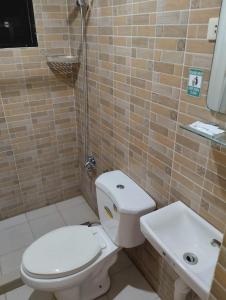 a bathroom with a toilet and a sink at Casa LeoMa in Cavite