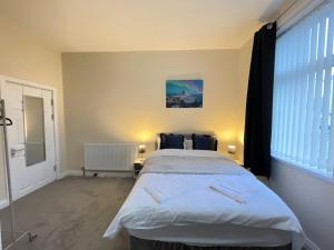 a bedroom with a large bed and a large window at Fogs Property - Darlington City Apartments in Darlington
