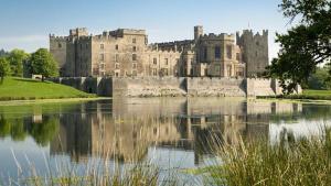 a castle with a lake in front of it at Fogs Property - Darlington City Apartments in Darlington