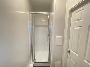 a shower with a glass door in a bathroom at Fogs Property - Darlington City Apartments in Darlington