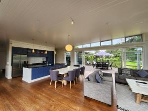 a kitchen and living room with a table and chairs at Hot Water Beach Escape in Hotwater Beach