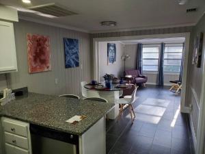 a kitchen and living room with a table and chairs at Beautiful cottage near Lake Louisa & mins from Disney, Vehicle Rental Available in Clermont