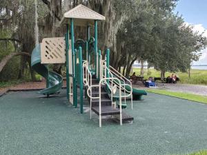 a playground with a slide in a park at Beautiful cottage near Lake Louisa & mins from Disney, Vehicle Rental Available in Clermont