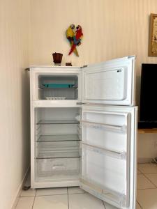 a white refrigerator with its door open in a room at Appartement vue mer in Le Moule