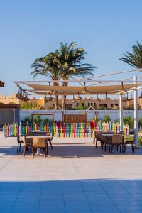 a group of tables and chairs under a pavilion at Scandic Rezort in Hurghada