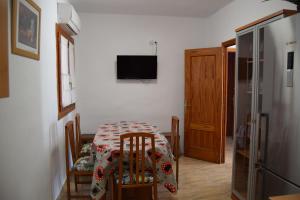 a dining room with a table and a television at Casa Rural Natalia in Valmuel