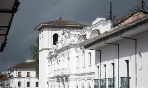 a white building with a bell tower on top of it at Hotel Dorado Real HDR in Popayan