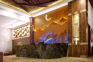 a lobby with a counter with a painting on the wall at HOTEL KARAYA DIVE RESORT in Santa Marta +84 photos