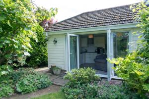 a garden room with a sliding glass door at Luxury Self Catering in Colchester in Colchester