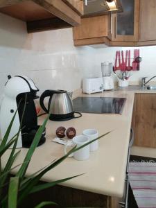 a kitchen counter with a tea kettle and cups on it at Great Ocean View and Lobos & Fuerteventura Islands in Tías