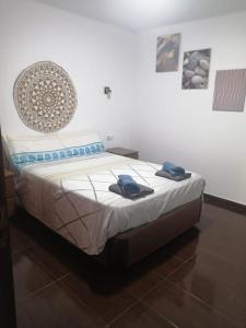 a bedroom with a bed with two towels on it at Great Ocean View and Lobos & Fuerteventura Islands in Tías