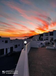 a view of a sunset from the roof of a building at Great Ocean View and Lobos & Fuerteventura Islands in Tías