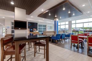 a dining room with a large table and chairs at Holiday Inn Express & Suites - Brighton, an IHG Hotel in Brighton