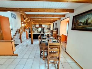 a dining room with a table and chairs at Stone House in Brittany near Sandy Beaches in Landéda +20 photos