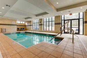 a swimming pool in a large room with a large window at Holiday Inn Mobile Airport by IHG in Mobile