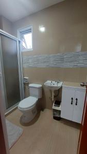 a bathroom with a toilet and a sink at Aussie Inn Baguio City Direct in Baguio