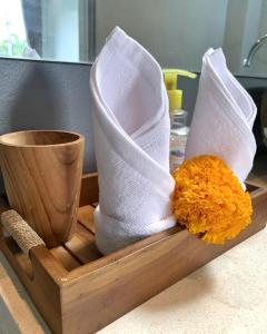 a wooden tray with white socks and a cup at The Palms Canggu in Canggu