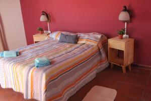 a bedroom with a bed and two night stands at La Casa Nostra in Río Cuarto