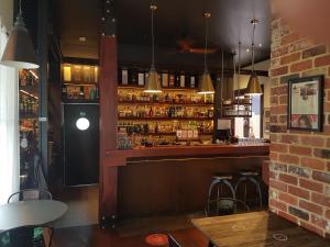 a bar in a restaurant with a lot of alcohol at Pemberton Japanese Garden Studio in Pemberton