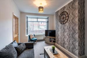 a living room with a couch and a tv at Family & Contractors & Free Parking & Airport Location in Doncaster