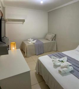 a hotel room with two beds and a television at Pousada Barreirinhas House in Barreirinhas +88 photos