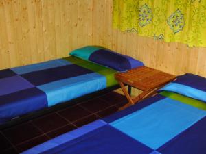 a room with two twin beds and a table at El Muerdago de Cañada in Cañada del Hoyo