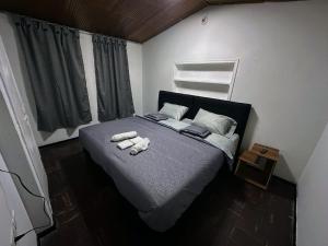 a bedroom with a bed with two towels on it at H&L BOUTIQUE in Bogotá
