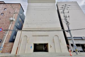 金海市Gracias Hotel Gimhae的大型白色建筑,设有大门廊