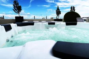 a hot tub with water in it on a roof at Le Dream Boutique Hotel in George Town