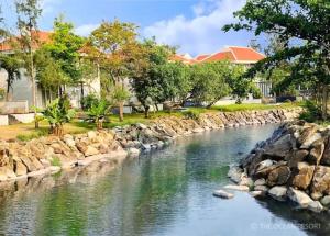 a river with rocks in front of a house at The Ocean Apartment IDCWH B602 in Danang