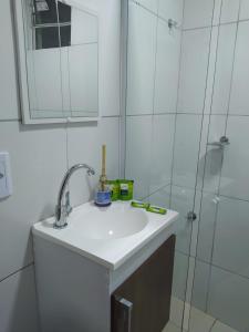 a bathroom with a sink and a shower at Pousada Barreirinhas House in Barreirinhas